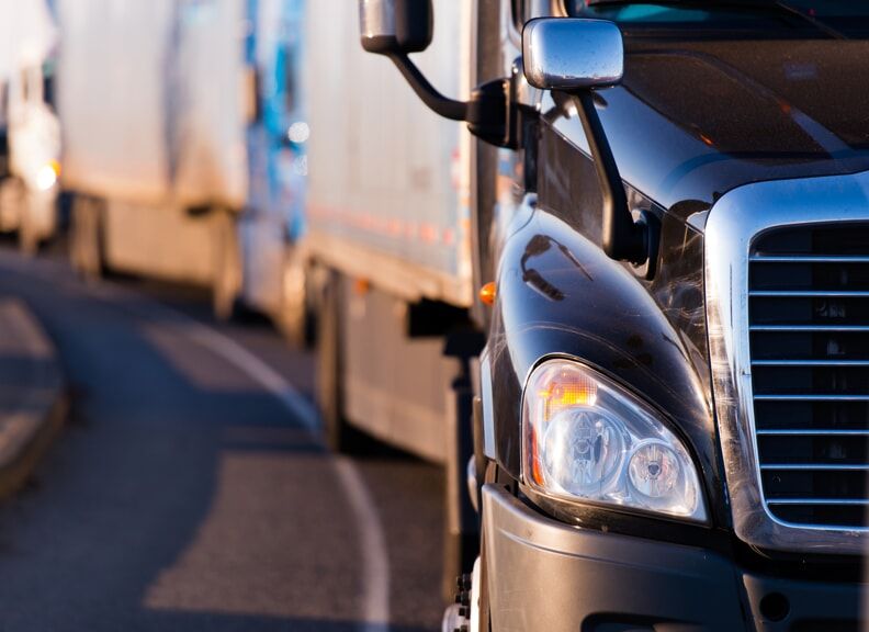 Line of semi-trucks driving